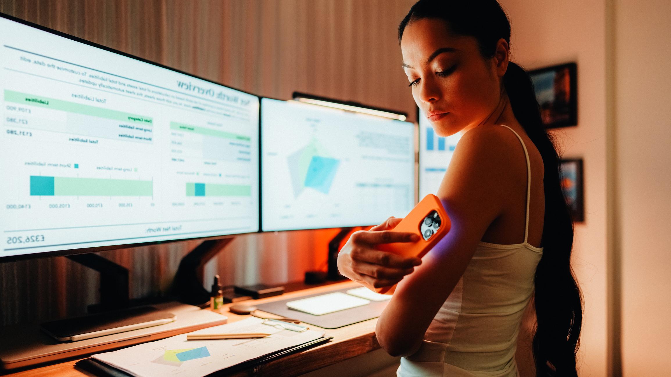 woman scanning arm with cell phone